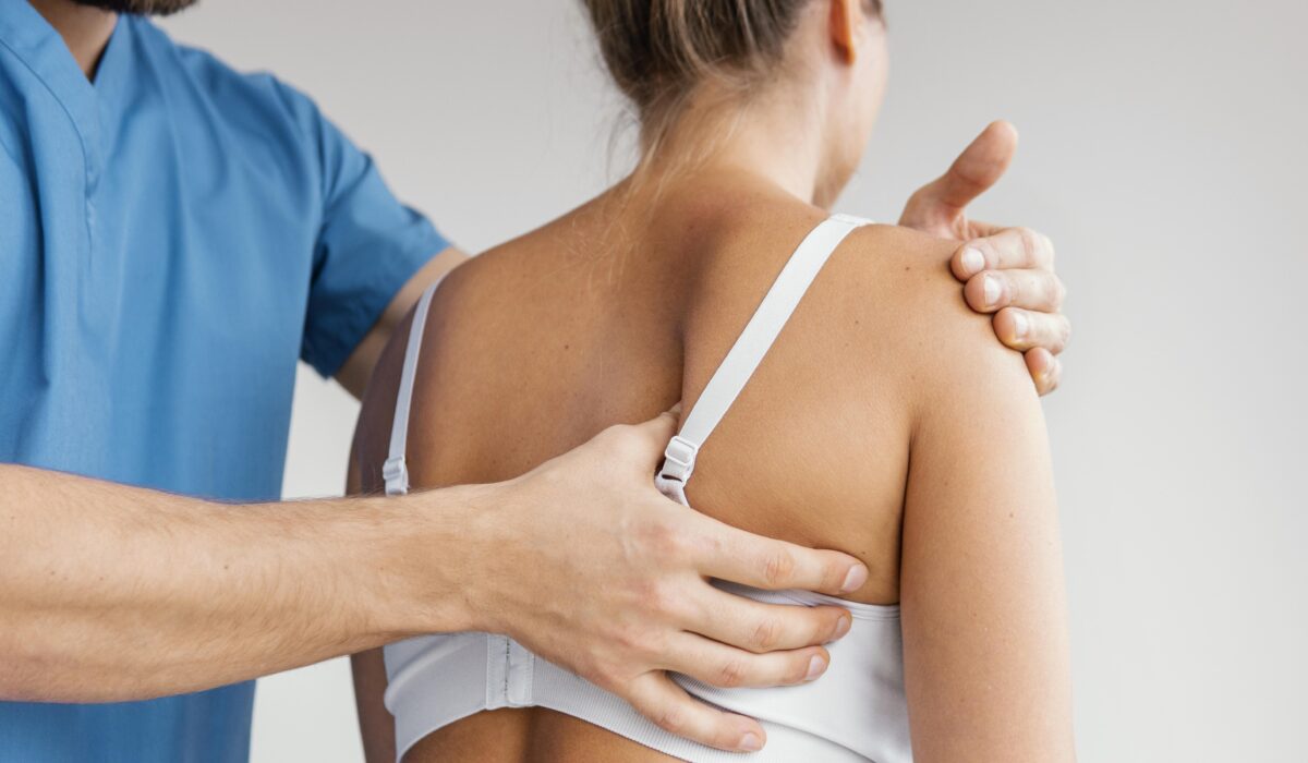 male-osteopathic-therapist-checking-female-patient-s-scapula